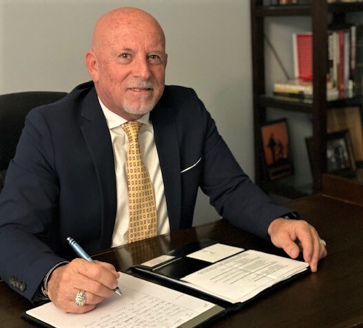 man at desk with papers